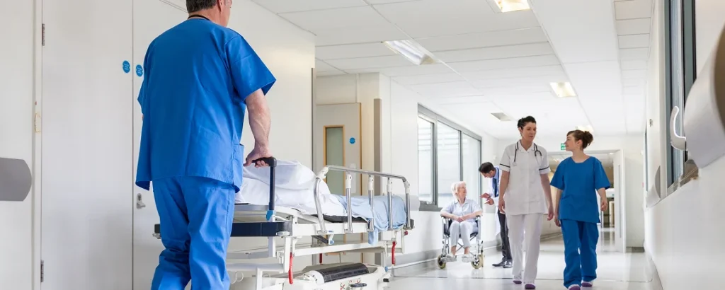 nursing and doctors walking through a busy hall